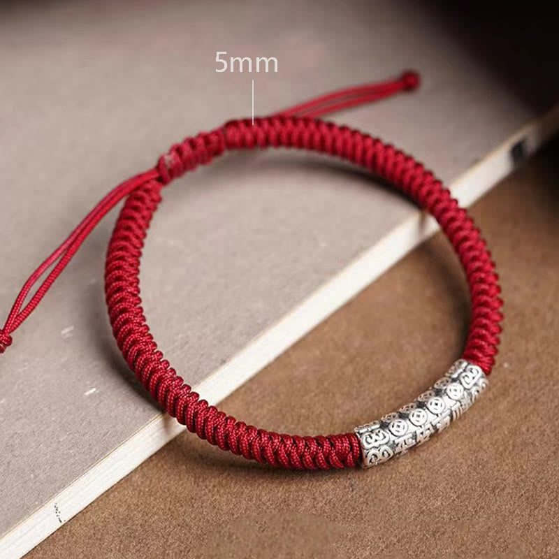 Silver Mantra Rope Bracelet – Close-up of 5mm red cord with engraved silver bead on dual-tone surface, cord bracelet
