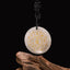 Om Mani Padme Hum Necklace – White quartz pendant with gold mantra on dark backdrop, crystal healing necklace