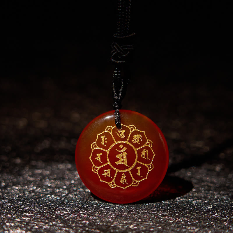Om Mani Padme Hum Necklace – Carnelian with gold mantra on dark textured surface, translucent red crystal