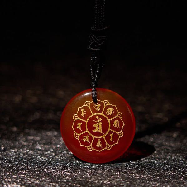 Om Mani Padme Hum Necklace – Carnelian with gold mantra on dark textured surface, translucent red crystal