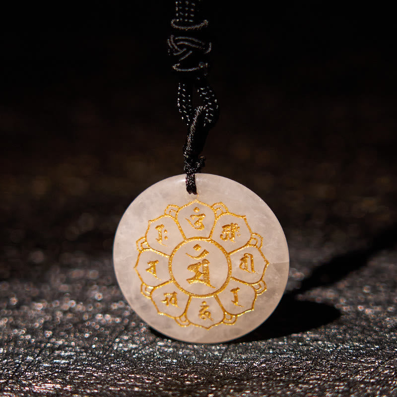Om Mani Padme Hum Necklace – Milky white quartz on black cord over dark fabric, translucent crystal pendant