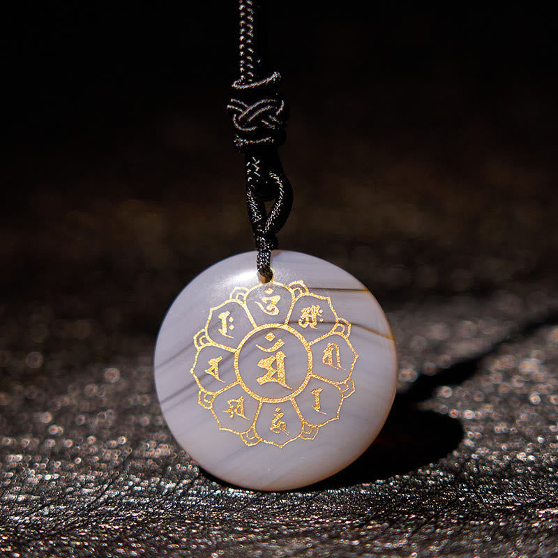 Om Mani Padme Hum Necklace – White banded agate with gold mantra on dark fabric, natural stone amulet