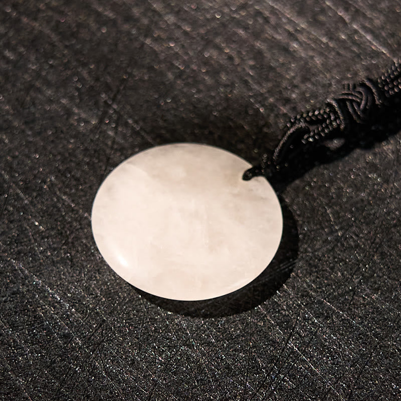 Om Mani Padme Hum Necklace – Overhead view of white quartz disc with natural veining and gold mantra, crystal amulet