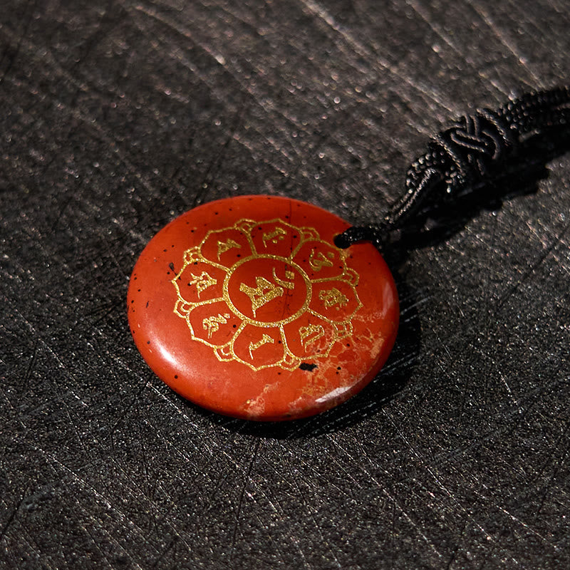 Om Mani Padme Hum Necklace – Top-down red jasper with gold lotus on dark wood grain, red stone necklace