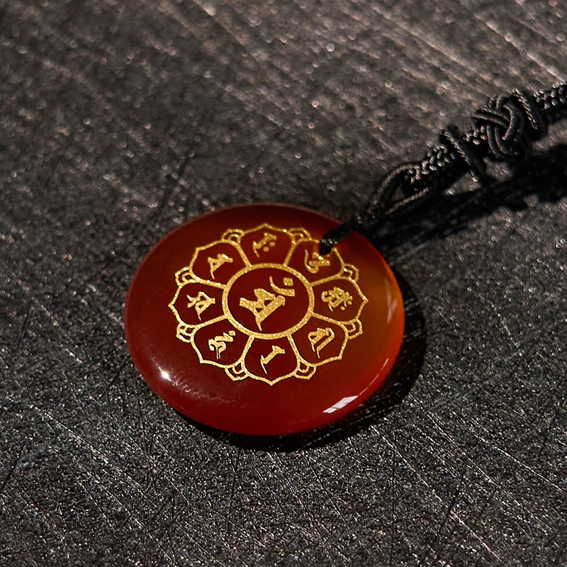 Om Mani Padme Hum Necklace – Carnelian at elevated angle showing dome on dark, orange crystal amulet