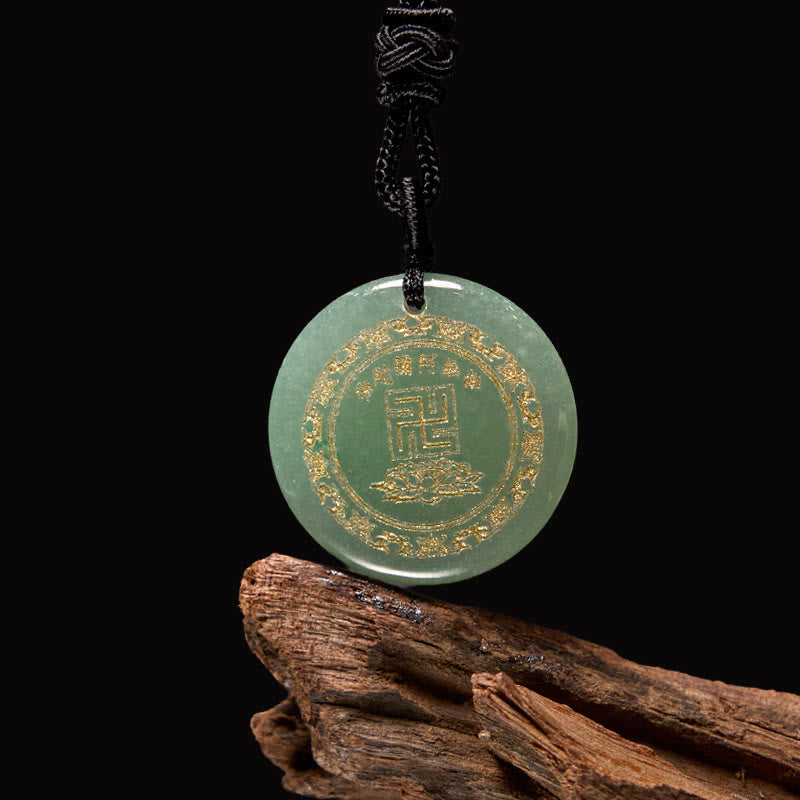 Green Jade Purification Pendant - celadon stone with gold lotus & seal on dark wood, black background, elegant