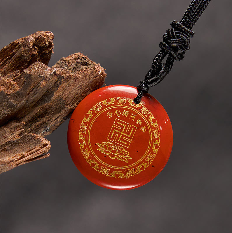 Cinnabar Red Purification Pendant - deep red stone gold swastika on gray, weathered wood prop, auspicious