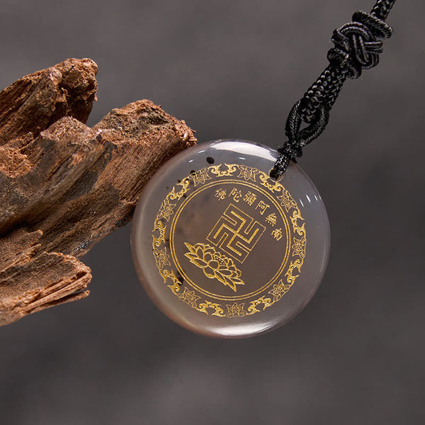 Gray Chalcedony Purification Pendant - warm gray stone gold mantra on gray backdrop, wood prop, contemplative