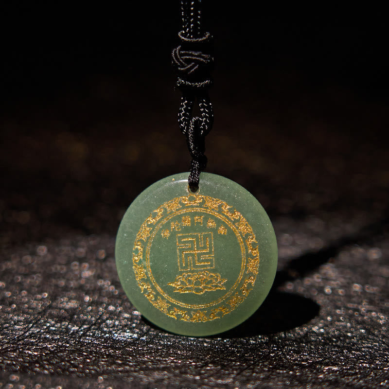 Green Jade Purification Pendant - sage green stone with gold swastika & lotus engraving, dark textured bg, reverent