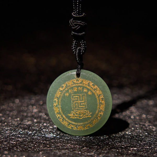 Green Jade Purification Pendant - sage green stone with gold swastika & lotus engraving, dark textured bg, reverent