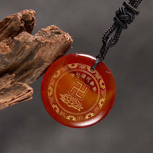Red Agate Purification Pendant - carnelian gold lotus & mantra, gray backdrop with driftwood, warm serene