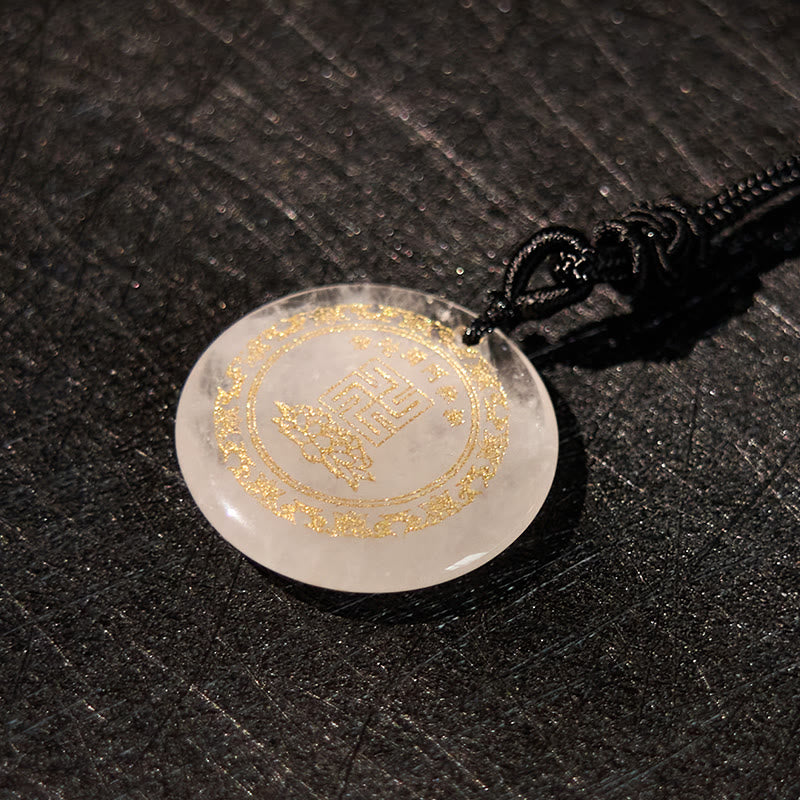 White Crystal Purification Pendant - milky translucent disc with gold engraving, dark textured background, artisanal mood