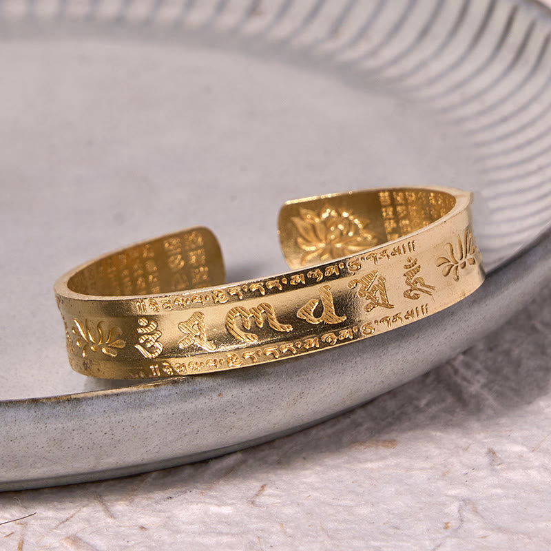 Heart Sutra Lotus Cuff Bracelet - lotus and Om symbol close-up on aged wood, awakening