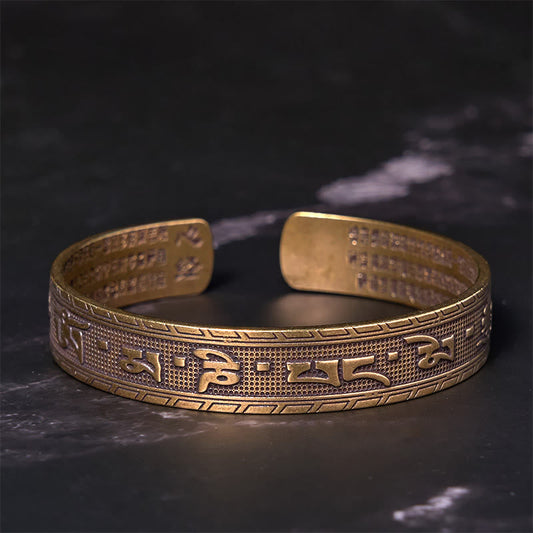 Om Mani Padme Hum Copper Brass Bangle – Low angle on black marble, inner sutra visible
