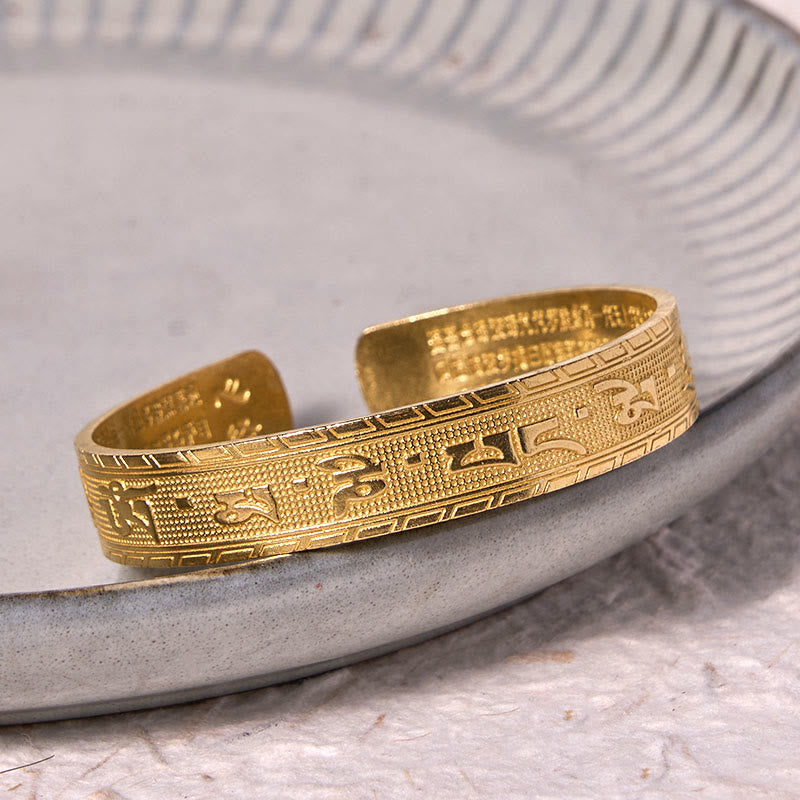 Om Mani Padme Hum Copper Brass Bangle – Side view on gray ceramic, Tibetan engraving