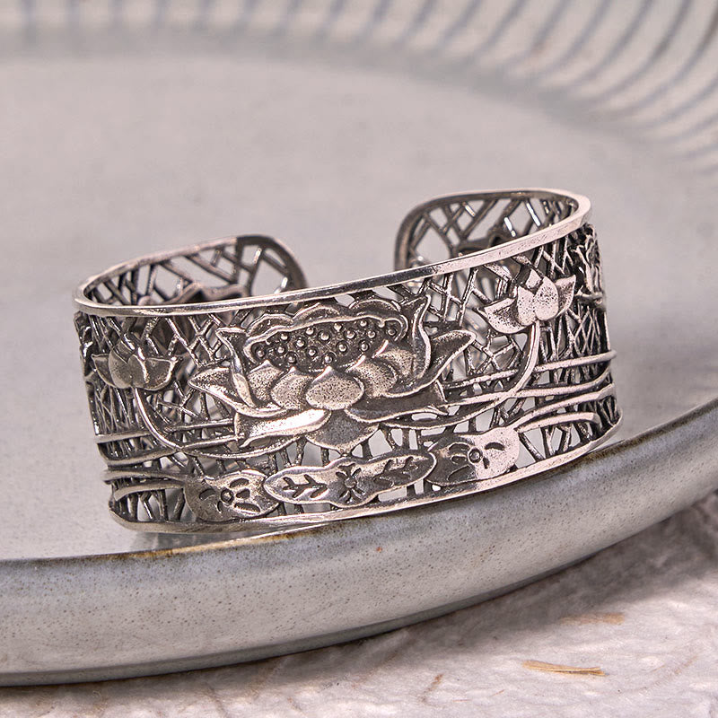 Hollow Lotus Silver Plated Copper Bracelet Bangle – silver openwork lotus on gray ceramic dish, spiritual