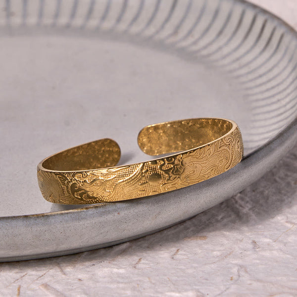 Dragon Phoenix Copper Brass Bracelet – Three-quarter on gray ceramic, engraved dragon cloud motifs, Traditional
