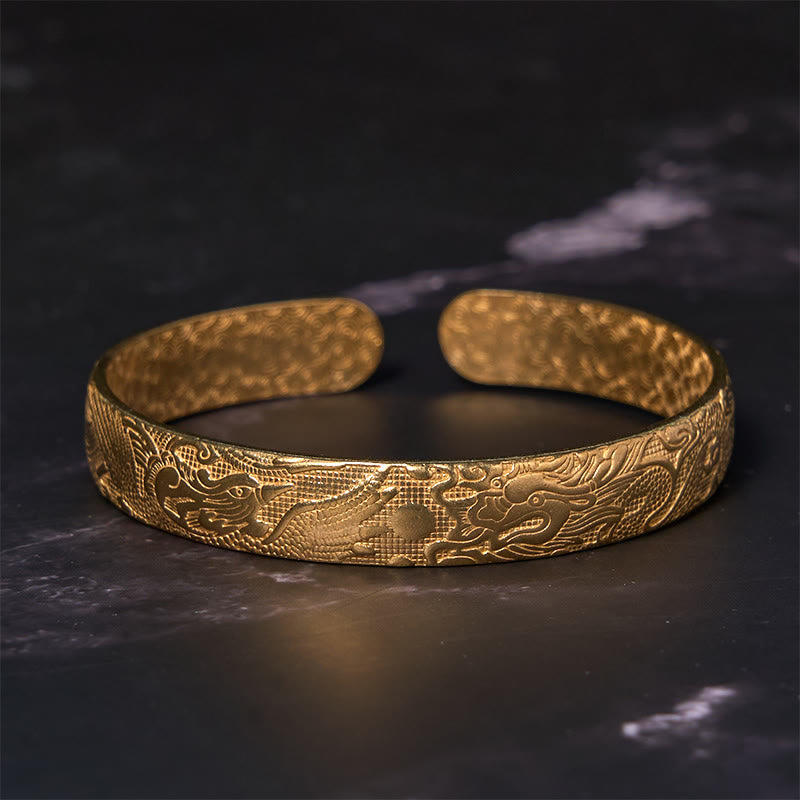 Dragon Phoenix Copper Brass Bracelet – Front view on dark marble, facing dragon heads relief, Valiant