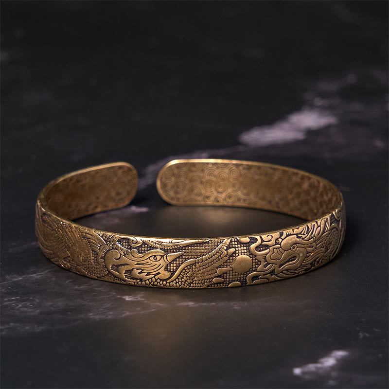 Dragon Phoenix Copper Brass Bracelet – Angled shot on black marble, intricate scale and feather engravings, Auspicious
