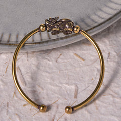 PiXiu Copper Bangle – Brass bangle with PiXiu Fu character on gray ceramic dish