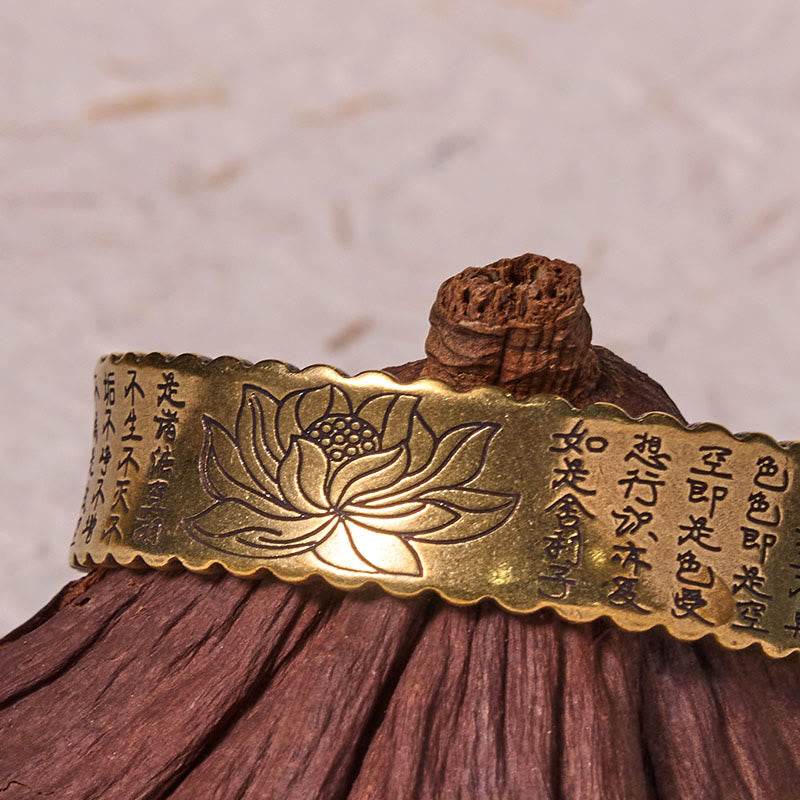 Heart Sutra Lotus Copper Cuff Bracelet – lotus and Heart Sutra calligraphy on wooden stand, warm gold, spiritual heritage