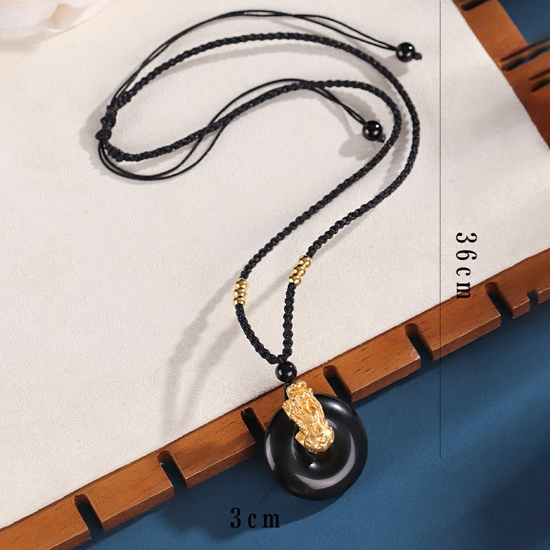 Black Onyx Agate Peace Buckle PiXiu Necklace – full necklace flat showing 36cm black cord length, white wood surface