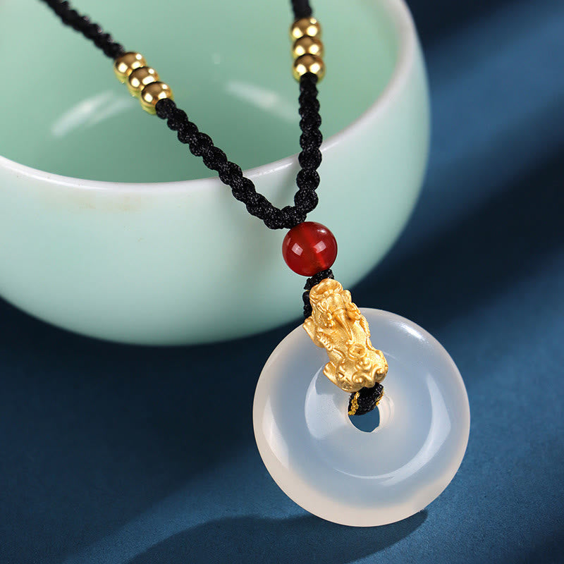 Black Onyx Agate Peace Buckle PiXiu Necklace – white agate peace buckle with gold PiXiu red bead, teal cup background
