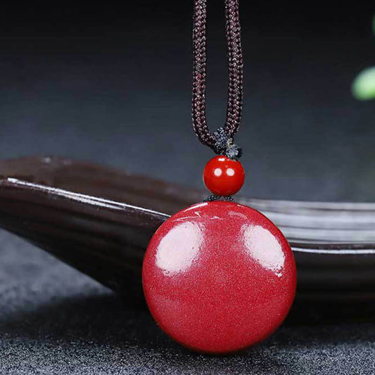 Cinnabar Yin Yang Necklace – polished red cinnabar pendant on dark braided cord, stone necklace