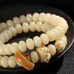 Bodhi Seed Lotus Bracelet – multi-loop cream beads with carved lotus center and gold stone-inlay spacers, zen style