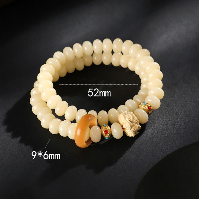 Bodhi Seed Lotus Bracelet – coiled ivory rondelle beads with amber ring and carved floral charm, artisan jewelry