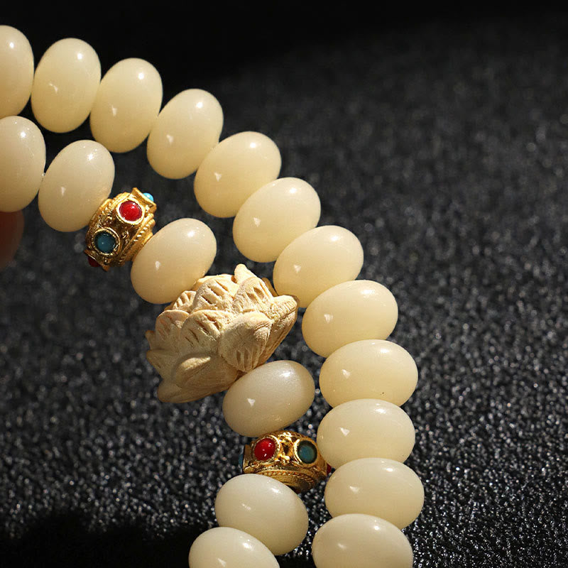 Bodhi Seed Lotus Bracelet – close-up cream oval beads with carved lotus and gold red turquoise inlay, detailed craft