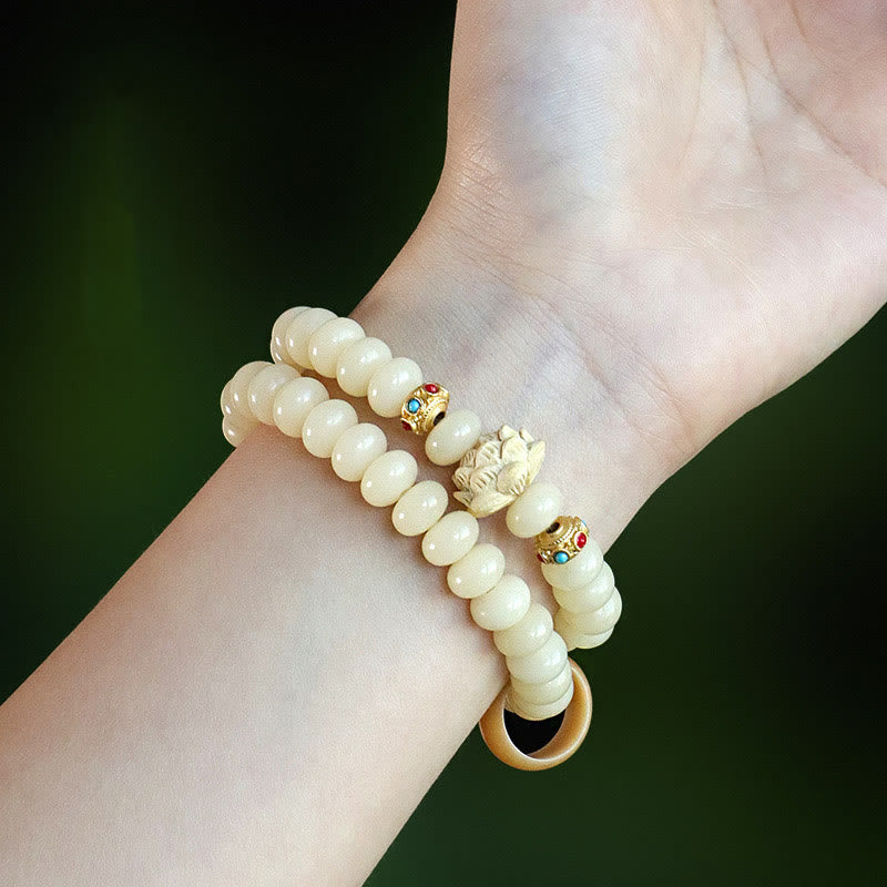 Bodhi Seed Lotus Bracelet – wrist shot against greenery with carved lotus focal bead, mindful living