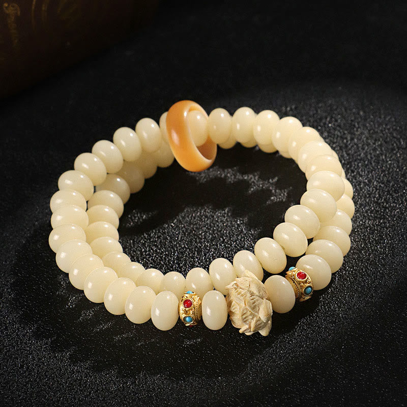 Bodhi Seed Lotus Bracelet – double-strand ivory beads with gold turquoise spacers and carved dragon, artisan craft
