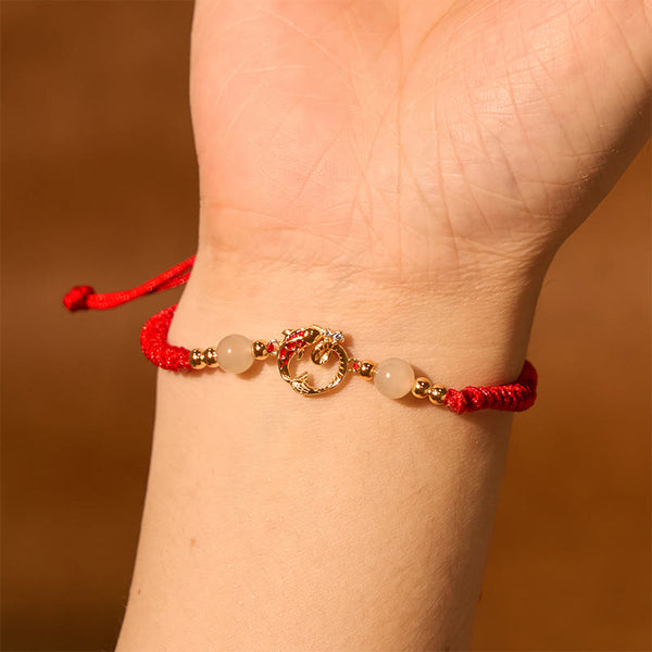 Silver Jade Cinnabar Koi Snake Bracelet – gold snake charm worn on wrist, amber background, zodiac protection jewelry