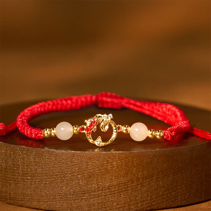 Silver Jade Cinnabar Koi Snake Bracelet – gold snake charm with white jade beads on wooden pedestal, prosperity jewelry