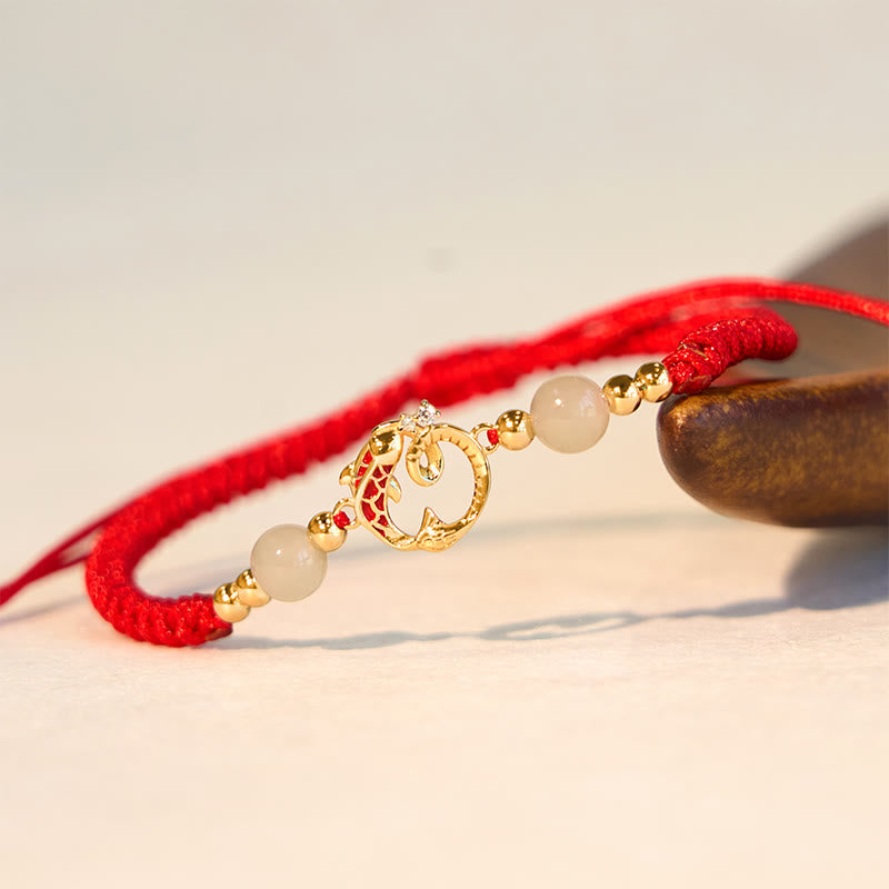 Silver Jade Cinnabar Koi Snake Bracelet – close-up gold koi circle charm with jade beads on cream stone, prosperity