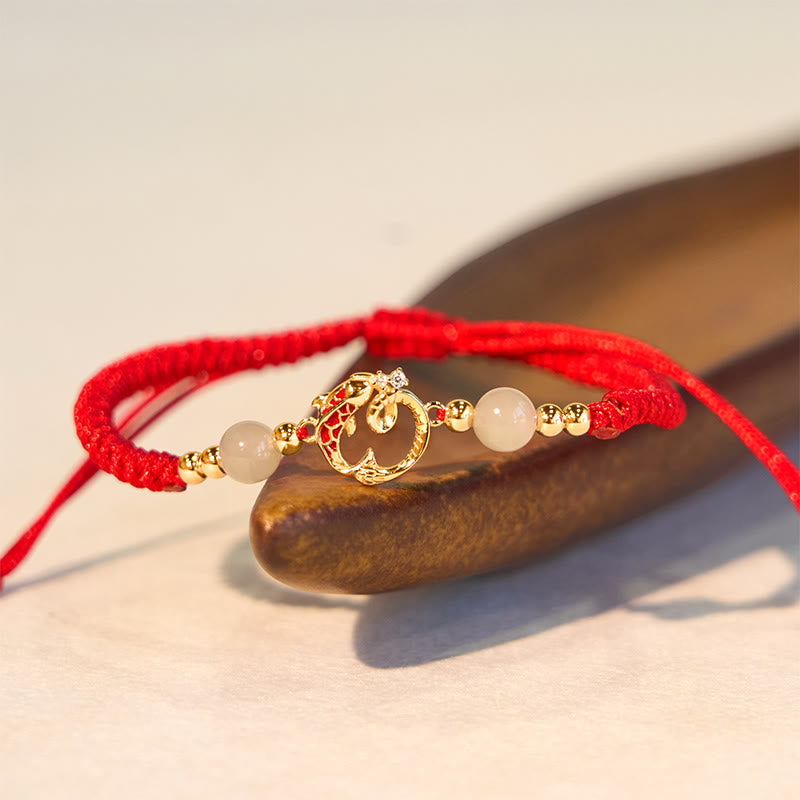 Silver Jade Cinnabar Koi Snake Bracelet – gold koi charm with jade beads on cream, wooden prop, adjustable cord