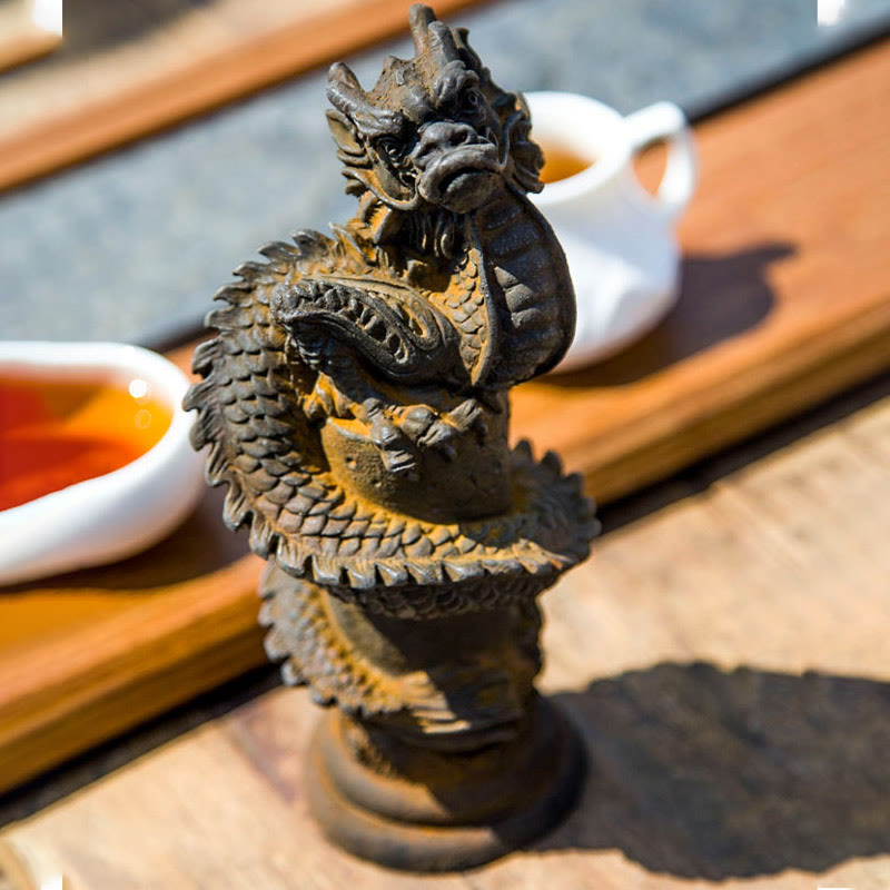 Flying Dragon Pillar Resin Statue – closeup frontal view with tea setting showing dragon head and scales, fortune decor