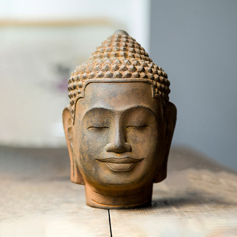 Meditating Buddha Head Resin Statue – light and shadow play on rust surface, dramatic photography
