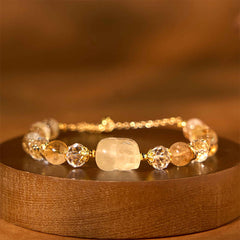Natural Citrine PiXiu Bracelet – closeup on dark brown wood side view PiXiu beads, prosperity bracelet
