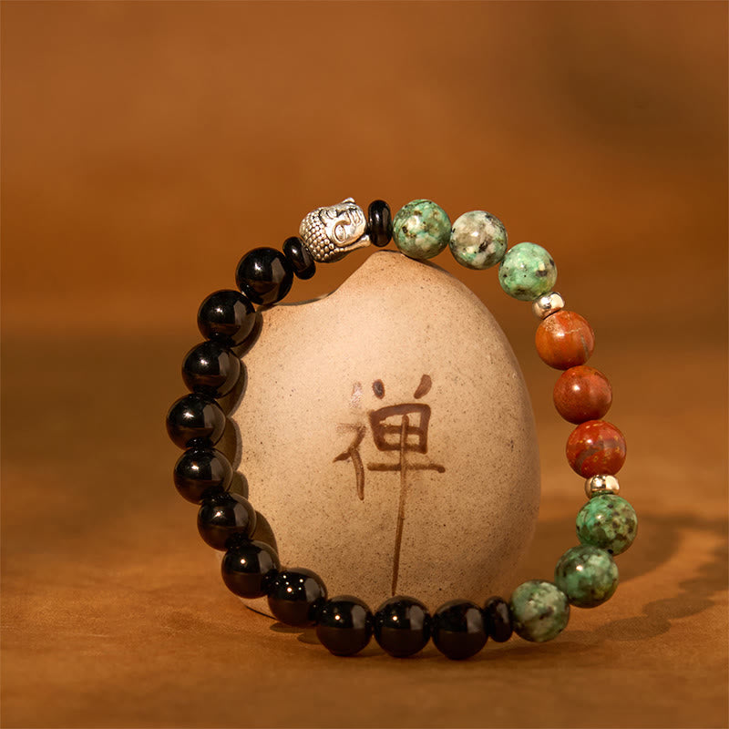 Mixed Gemstone Buddha Head Bracelet – hand holding bracelet showing Buddha head detail, natural stone bead texture