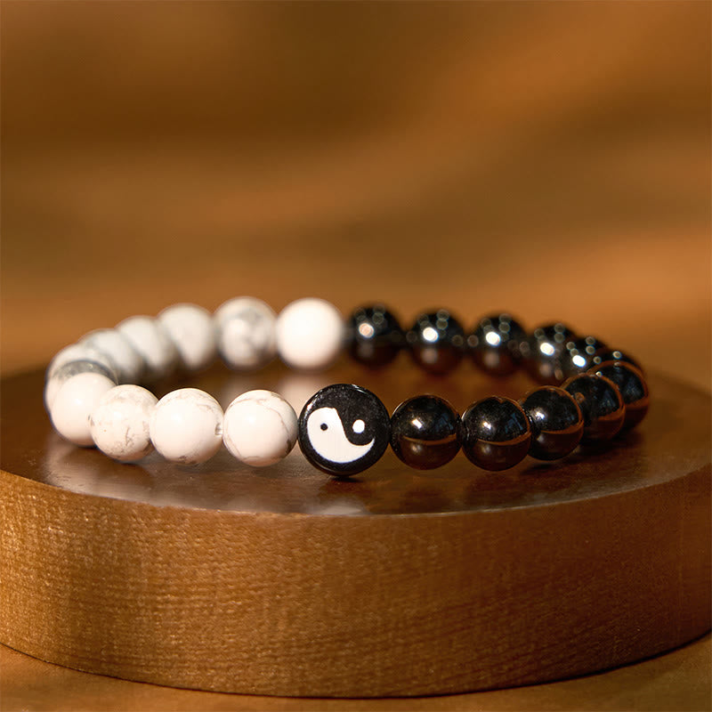 Obsidian White Turquoise Yin Yang Bracelet - black obsidian and white howlite beads with yin-yang center on wood stand, ba...