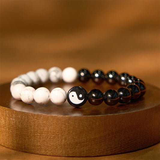 Obsidian White Turquoise Yin Yang Bracelet - black obsidian and white howlite beads with yin-yang center on wood stand, ba...
