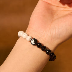 Obsidian White Turquoise Yin Yang Bracelet - worn on wrist showing glossy obsidian and matte white turquoise beads with yi...