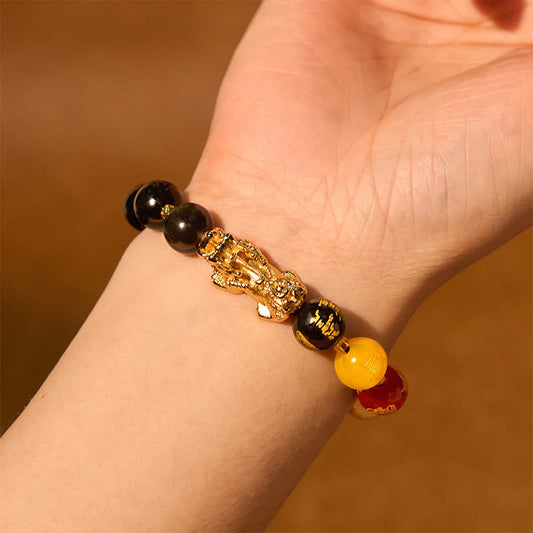 Gold Sheen Obsidian PiXiu Bracelet – worn on wrist with gold PiXiu, warm lighting, five directions gods bead