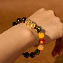 Gold Sheen Obsidian PiXiu Bracelet – wrist view showing all beads, gold PiXiu center, wealth protection charm