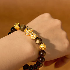 Gold Sheen Obsidian PiXiu Bracelet – Wrist shot showing gold PiXiu and carved beads, obsidian bracelet