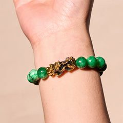 PiXiu Jade Bracelet – Worn on wrist showing gold PiXiu and green jade beads, feng shui jewelry