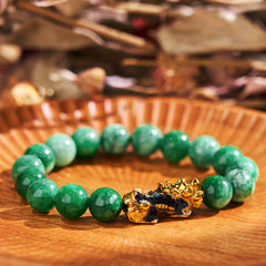 PiXiu Jade Bracelet – Green jade beads with gold PiXiu on wooden plate, success luck jewelry