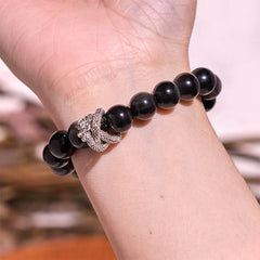 Silver Sheen Obsidian Dragon Bracelet – worn on wrist showing dragon charm scale, polished obsidian beads, protective